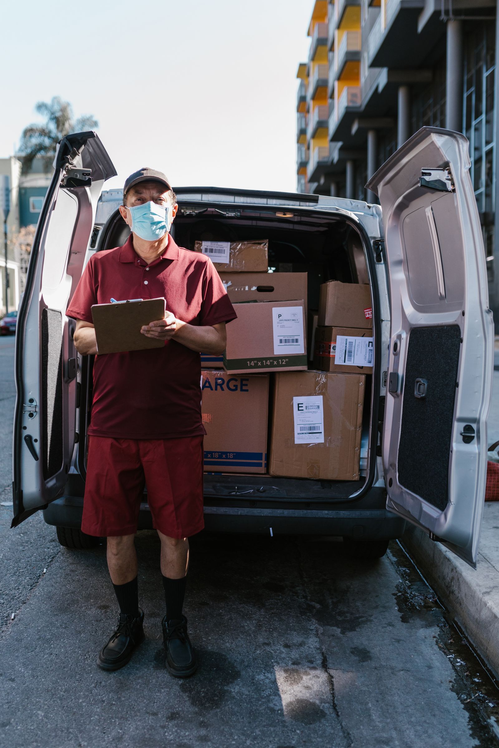 Relo delivery worker with parcels at the van for same-day courier delivery in Singapore