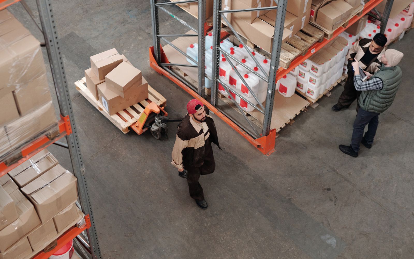 Relo general crew moving stock with a pallet jack in a Singapore warehouse